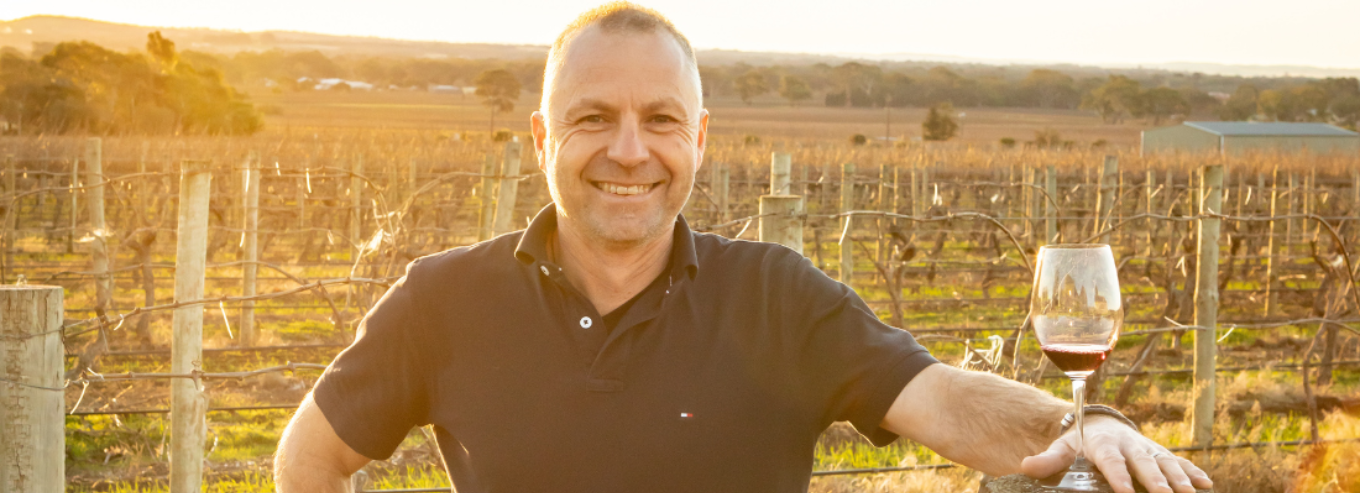 Jason in Schwarz Wine Company Vineyard with glass